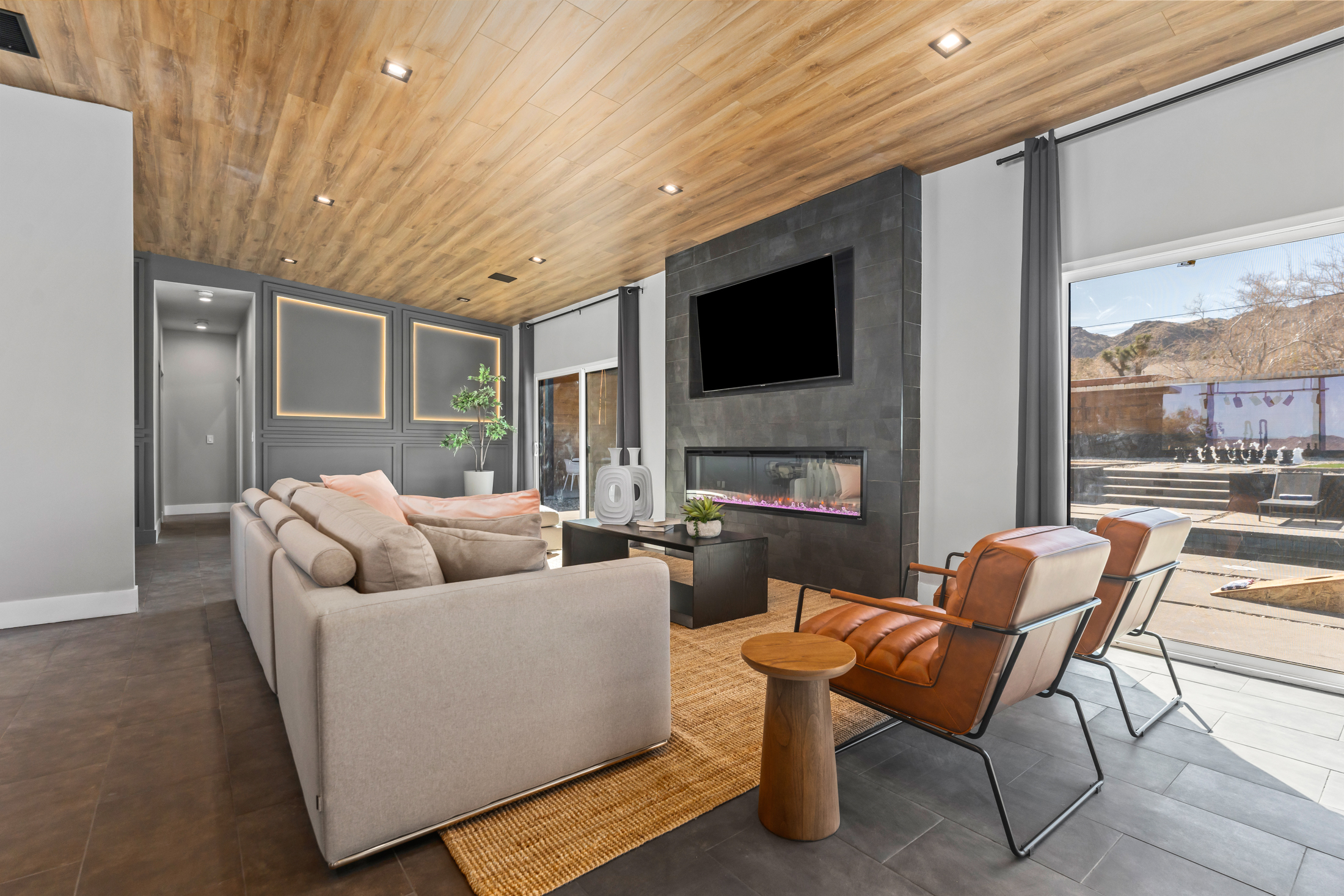 Living room with electric fireplace and desert views
